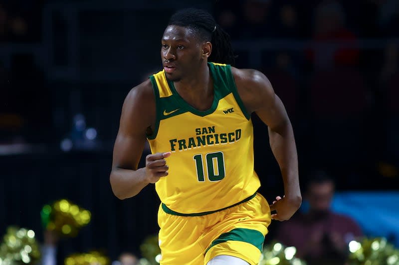 San Francisco forward Jonathan Mogbo runs up the court during the second half of an NCAA college basketball game against Gonzaga in the semifinals of the West Coast Conference men's tournament Monday, March 11, 2024, in Las Vegas. | Ellen Schmidt