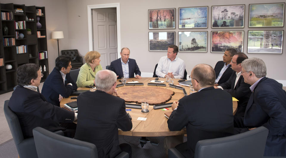 FILE - Leaders of the G-8 meet during a round table session at the G-8 summit at the Lough Erne golf resort in Enniskillen, Northern Ireland, on Tuesday, June 18, 2013. From left clockwise, European Commission President Jose Manuel Barroso, Japan's Prime Minister Shinzo Abe, German Chancellor Angela Merkel, Russian President Vladimir Putin, British Prime Minister David Cameron, US President Barack Obama, French President Francois Hollande, Canadian Prime Minister Stephen Harper, Italian Prime Minister Enrico Letta. (AP Photo/Stefan Rousseau, Pool, File)