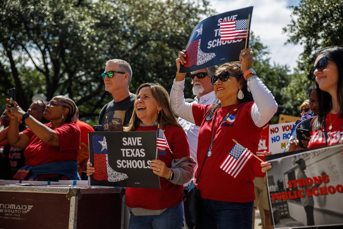 Members of the crowd hold signs and chant during a rally against school vouchers at the Texas Capitol on Oct. 7, 2023. Hundreds gathered to protest two days before a special session was slated to begin on Oct. 9, 2023.