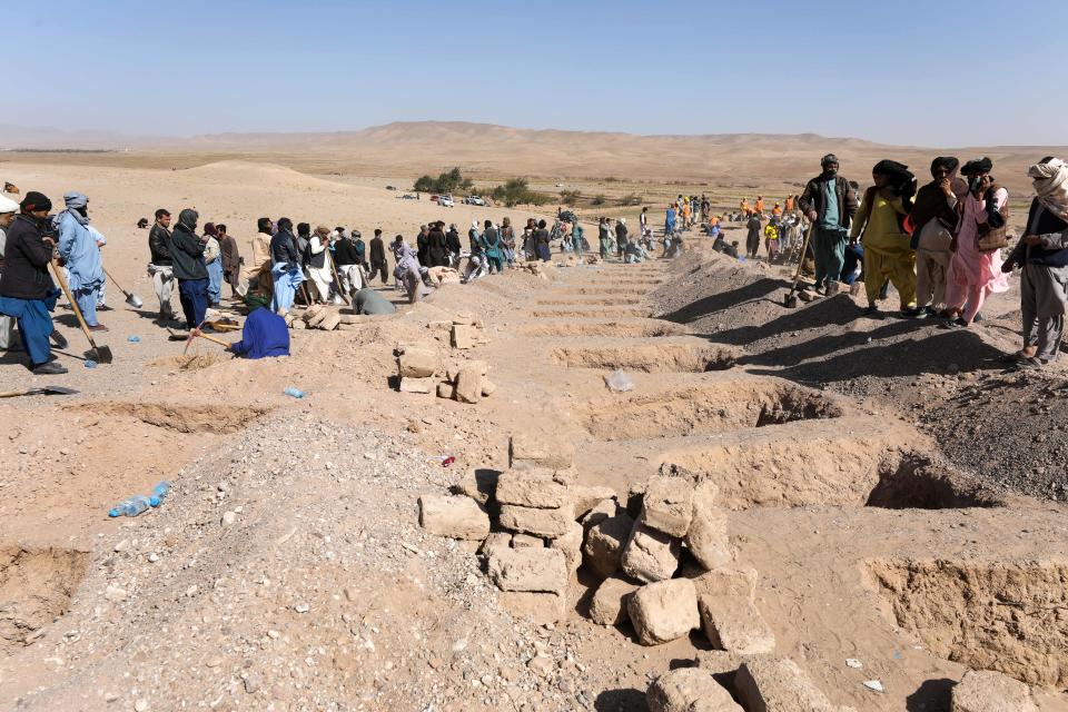 People digging graves in Afghanistan.