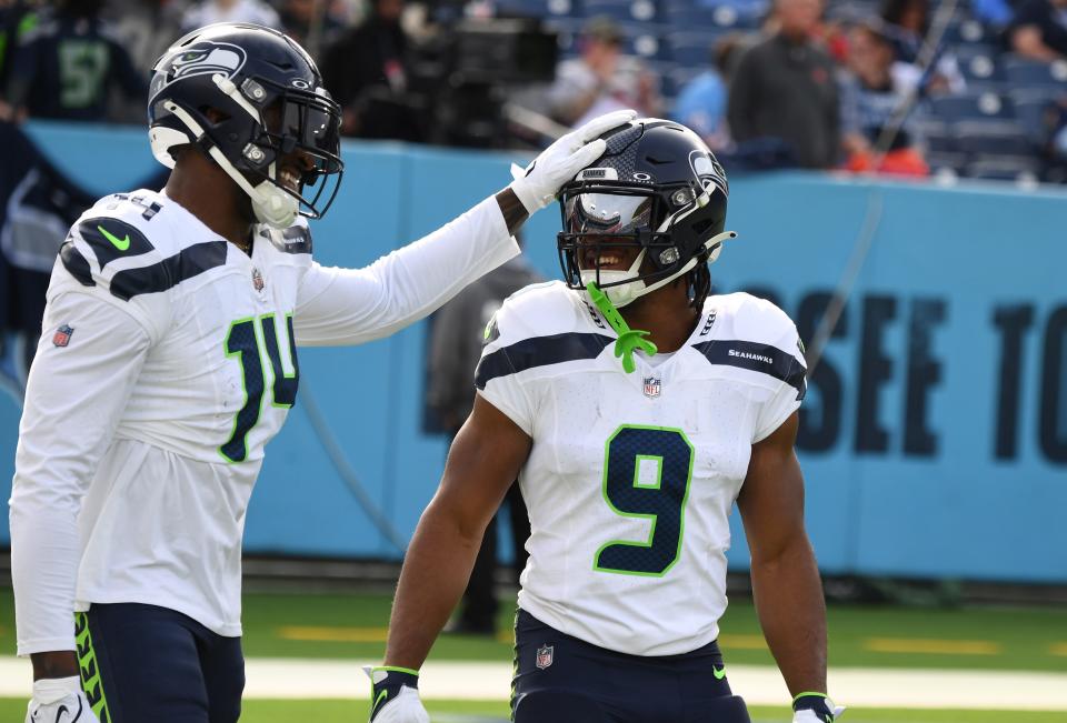Dec 24, 2023; Nashville, Tennessee, USA; Seattle Seahawks wide receiver DK Metcalf (14) and running back Kenneth Walker III (9) before the game against the Tennessee Titans at Nissan Stadium. Mandatory Credit: Christopher Hanewinckel-USA TODAY Sports ORG XMIT: IMAGN-710734 ORIG FILE ID: 20231224_szo_ah2_0056.JPG