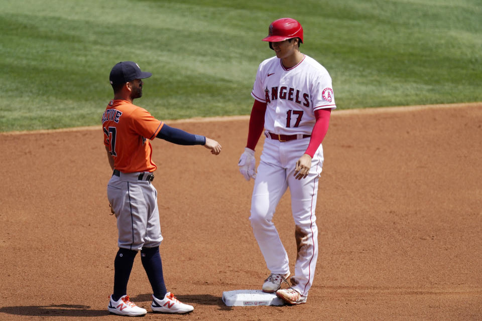 Los Angeles Angels' Shohei Ohtani, right, talks to Houston Astros second baseman Jose Altuve after stealing second during the first inning of a baseball game Tuesday, April 6, 2021, in Anaheim, Calif. (AP Photo/Mark J. Terrill)