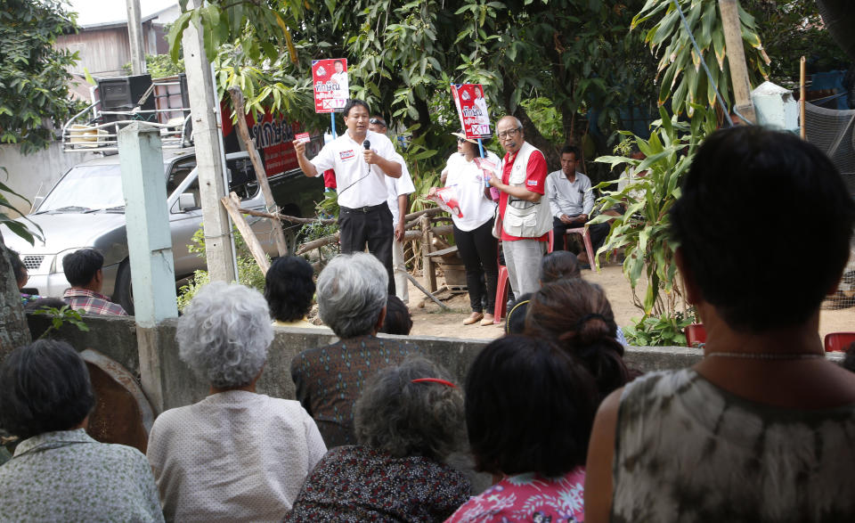 In this March 14, 2019, photo, Veerawit Chuajunud, center left, who changed his name to Thaksin Chuajunud of Pheu Chart party, speaks during an election campaign in Nakhon Ratchasima, Thailand. Thailand’s former Prime Minister Thaksin Shinawatra is in exile and banned from interfering in the country’s politics. But his name is a powerful political attraction and in tribute, and to win votes, some candidates in general election on Sunday, March 24, 2019 have changed their names to Thaksin so supporters of the former leader can register their loyalty at the ballot box. (AP Photo/Sakchai Lalit)