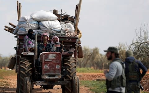 Residents of the town of Inab, eastern Afrin, Syria, flee a Turkey-backed rebel offensive - Credit: Reuters