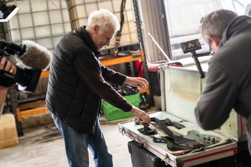 Phil Mitchell takes his 54-year-old bass guitar from its case