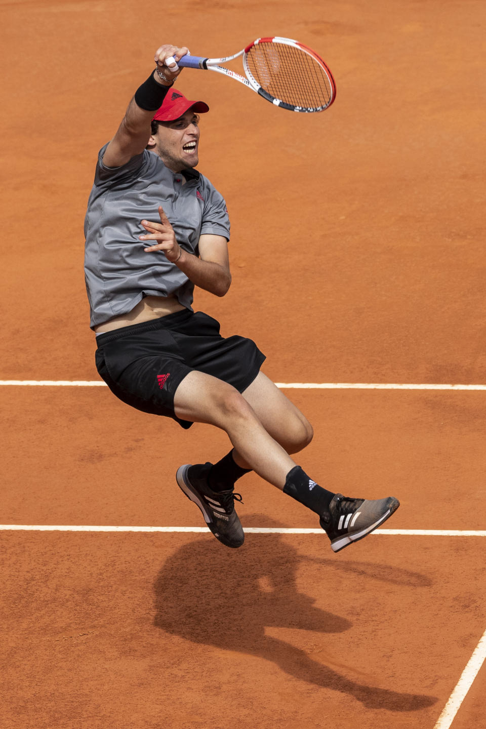 Austria's Dominic Thiem returns the ball to Germany's Alexander Zverev during their semi-final match at the Mutua Madrid Open tennis tournament in Madrid, Spain, Saturday, May 8, 2021. (AP Photo/Bernat Armangue)