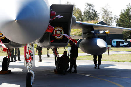 Polish Air Force officers look at U.S. Air Force F-15C Eagle fighter during NATO Baltic air policing mission takeover ceremony in Siauliai, Lithuania August 30, 2017. REUTERS/Ints Kalnins