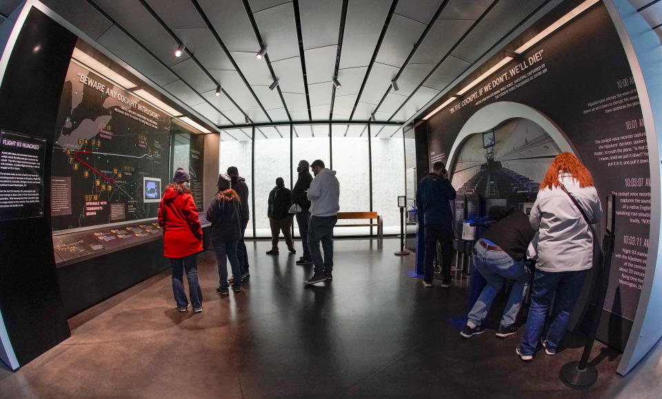 Visitors look over exhibits at the visitors center of the Flight 93 National Memorial, Saturday, May 8, 2021, in Shanksville, Pa. The families of Flight 93's 40 passengers and crew members are starting an annual award to reward selfless acts of heroism and educate the public. (AP Photo/Keith Srakocic)