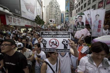 Thousands of pro-democracy protesters gather to march in the streets to demand universal suffrage in Hong Kong July 1, 2014. REUTERS/Tyrone Siu