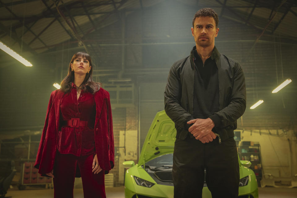 This image released by Netflix shows Kaya Scodelario, left, and Theo James from the Netflix series "The Gentlemen." (Christopher Rafael/Netflix via AP)