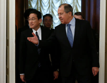 Russian Foreign Minister Sergei Lavrov shows the way to his Japanese counterpart Fumio Kishida during a meeting in Moscow, Russia, December 3, 2016. REUTERS/Sergei Karpukhin