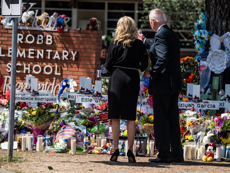 US President Joe Biden and First Lady Jill Biden pay their respects at a makeshift memorial outside of Robb Elementary School in Uvalde, Texas on May 29, 2022. (Photo by CHANDAN KHANNA/AFP via Getty Images)