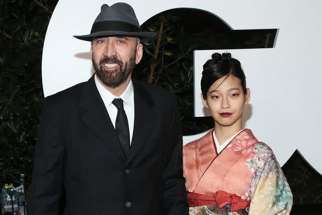 <p>Phillip Faraone/FilmMagic</p> Nicholas Cage and Riko Shibata attend the GQ Men Of The Year Celebration on November 18, 2021 in West Hollywood, California