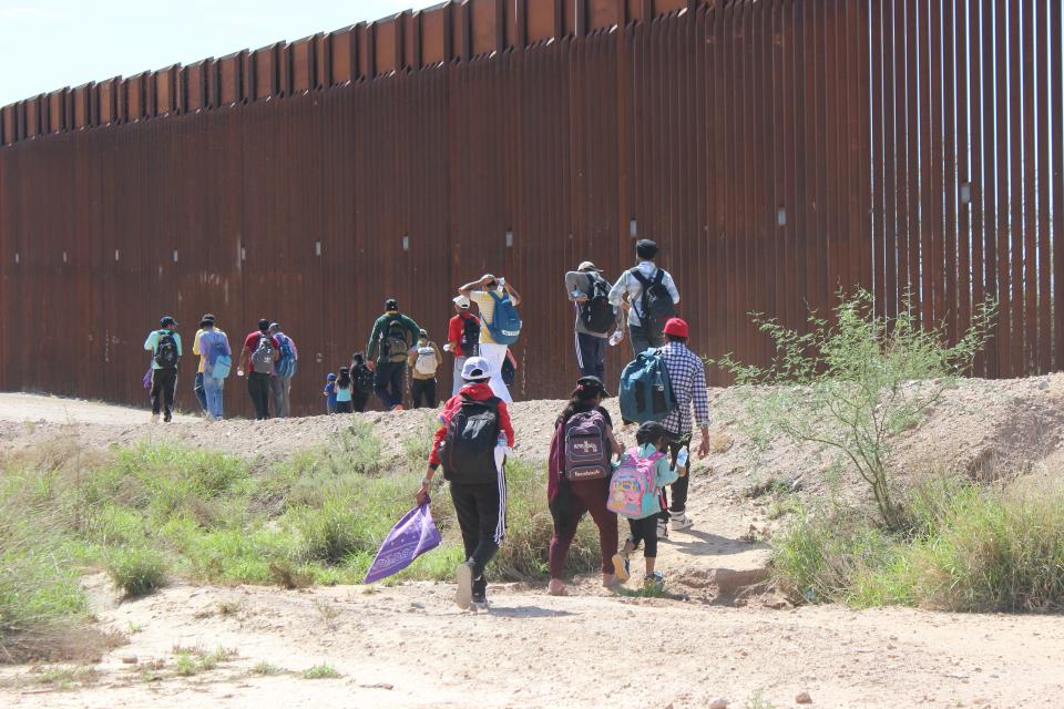 A group of roughly 50 migrants, mostly from India, continue their walk toward a Border Patrol processing center on the Organ Pipe Cactus National Monument west of Lukeville on Aug. 22, 2023.
