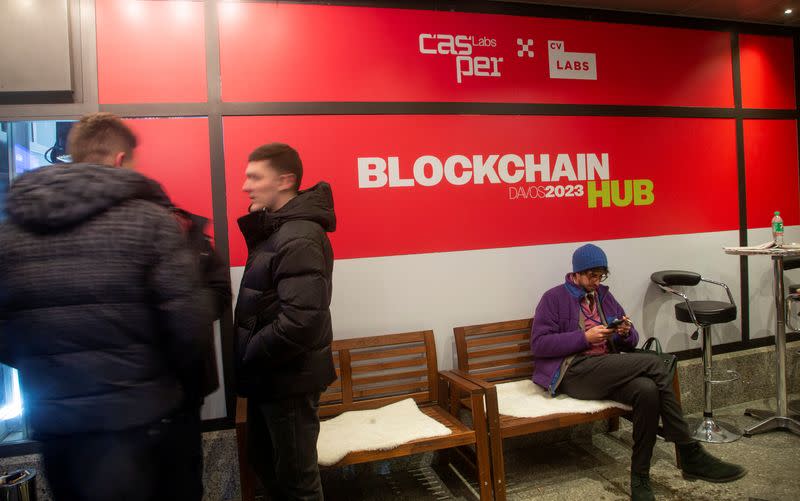 People stand in front of the Blockchain Hub Davos 2023 during the World Economic Forum in Davos