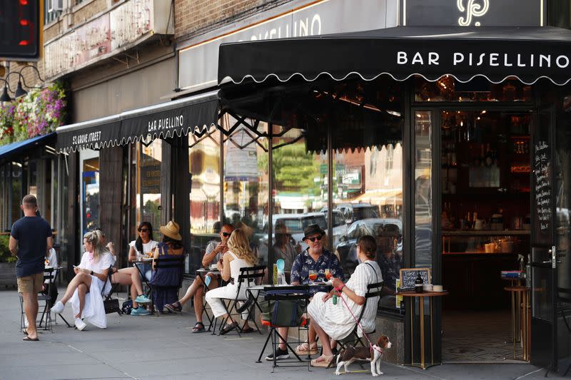 Customers practice social distancing in outdoor seating at a restaurant in New York City
