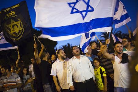 Right-wing activists hold Israeli national flags, during a protest in support of a hunger-striking Palestinian prisoner, Mohammed Allan, in the southern city of Ashkelon August 16, 2015. REUTERS/Amir Cohen