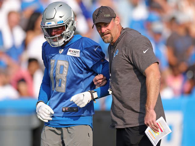 <p>Leon Halip/Getty</p> Geronimo Allison #18 of the Detroit Lions talks with head coach Dan Campbell during Training Camp on July 31, 2021.