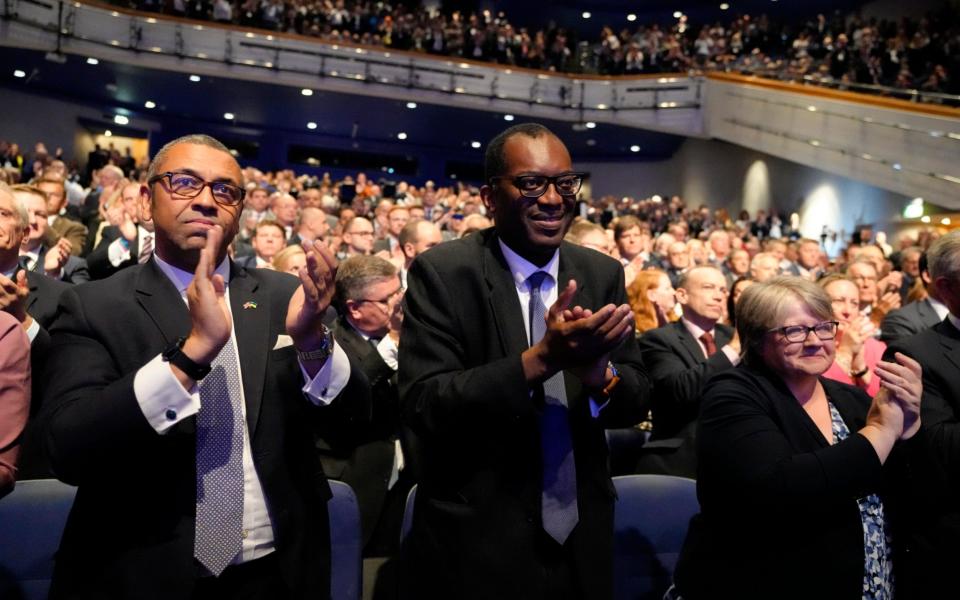 James Cleverly, Kwasi Kwarteng and Therese Coffey applaud as Liz Truss delivers her speech in Birmingham today - Kirsty Wigglesworth/AP