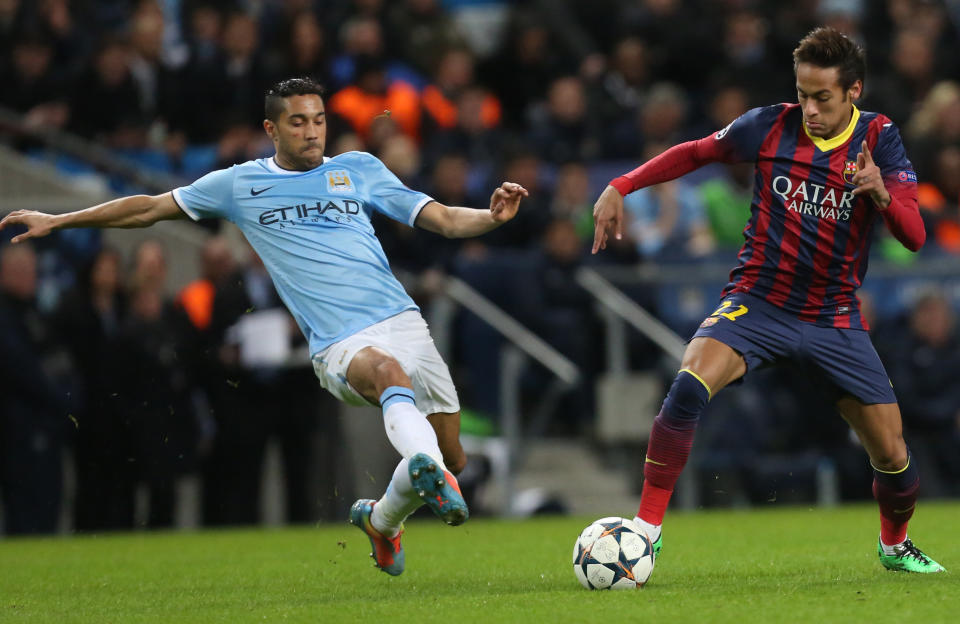 Barcelona's Neymar fights for the ball Manchester City's Gael Clichy, left, during their Champions League first knock out round soccer match at the Etihad Stadium, Manchester, England, Tuesday Feb. 18, 2014. (AP Photo/Jon Super)