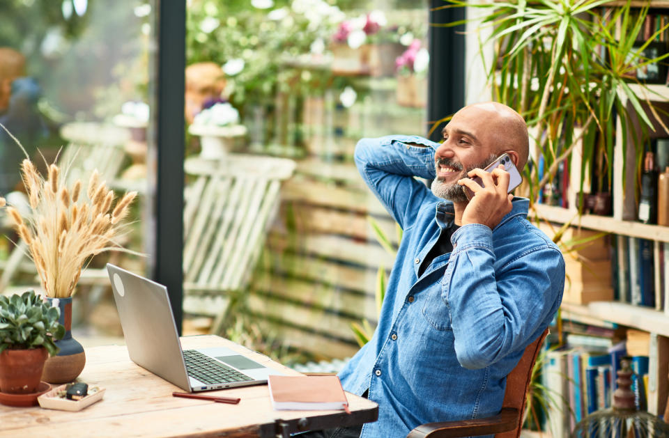 man at his desk on the phone