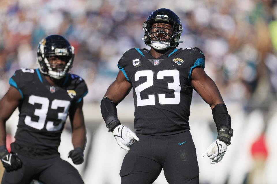 Jacksonville Jaguars linebacker Foyesade Oluokun (23) reacts to his third down stop as teammate linebacker Devin Lloyd (33) looks on during the second quarter of a regular season NFL football matchup Sunday, Dec. 18, 2022 at TIAA Bank Field in Jacksonville. [Corey Perrine/Florida Times-Union]