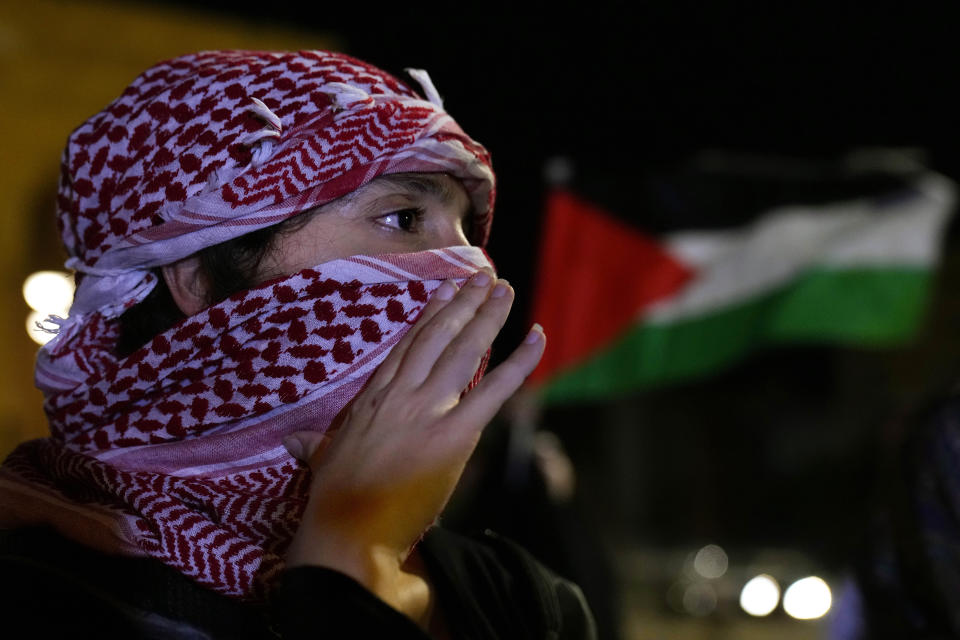 A demonstrators chants slogans during a protest in solidarity with the Palestinian people in Gaza, at Martyrs' Square in downtown Beirut, Lebanon, Tuesday, Oct. 17, 2023. Groups of protesters roamed the city on motorcycles and gathered outside the French embassy, and the headquarters of the U.N. Economic and Social Commission for Western Asia. They were unable to reach the heavily fortified U.S. embassy compound in the hills north of Beirut. (AP Photo/Bilal Hussein)