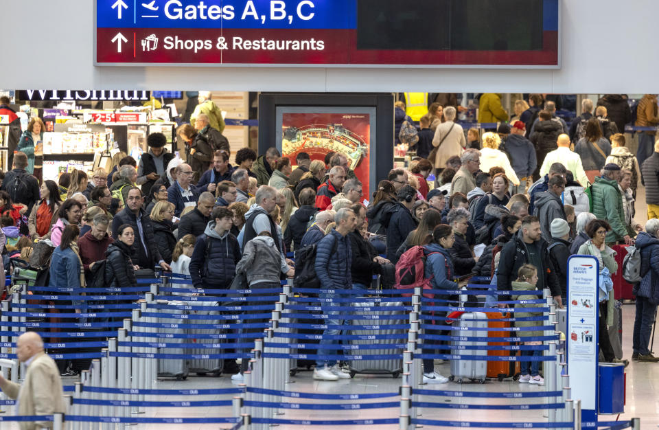 Travelers wait in the departure hall at Dusseldorf Airport, Duesseldorf, Germany, Friday Dec. 22, 2023, at the start of the Christmas vacations. (Thomas Banneyer/dpa via AP)