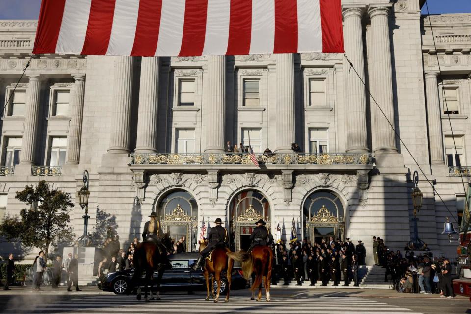 Mounted police and other law enforcement in formation outside San Francisco City Hall.