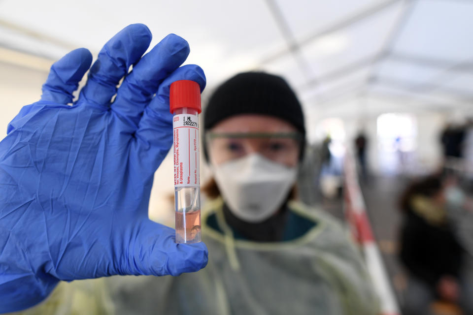 A medical employee presents a smear taken at a special corona test center for public service employees such as police officers, nurses and firefighters during a media presentation as the spread of the coronavirus disease (COVID-19) continues, in Munich, Germany, March 23, 2020. REUTERS/Andreas Gebert