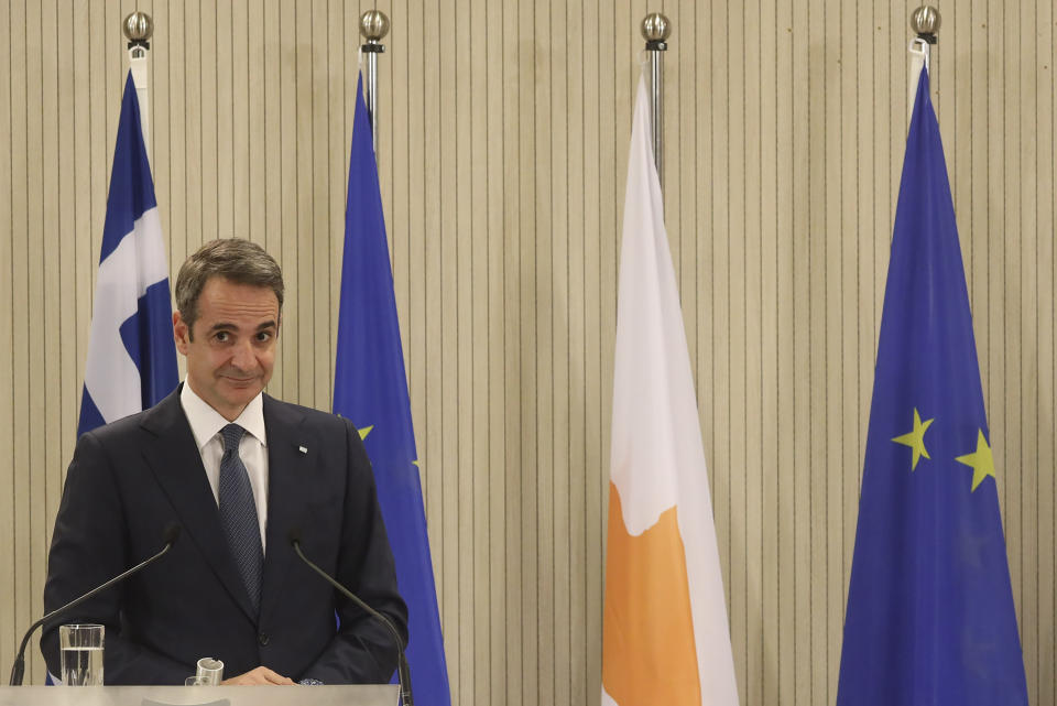 This image provided from Cyprus' press and information office, Greece's Prime minister Kyriakos Mitsotakis is seen during a press conference after a meeting with Cyprus President Nicos Anastasiades at the presidential palace in capital Nicosia, Cyprus, on Monday, Feb. 8, 2021. Mitsotakis is in Cyprus for one-day official visit. (Stavros Ioannides, PIO via AP)