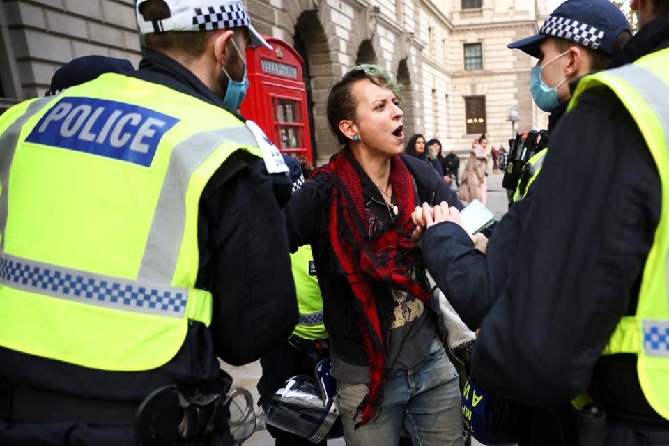 <p>Police hancuffed protesters as they marched through the streets of London</p>REUTERS