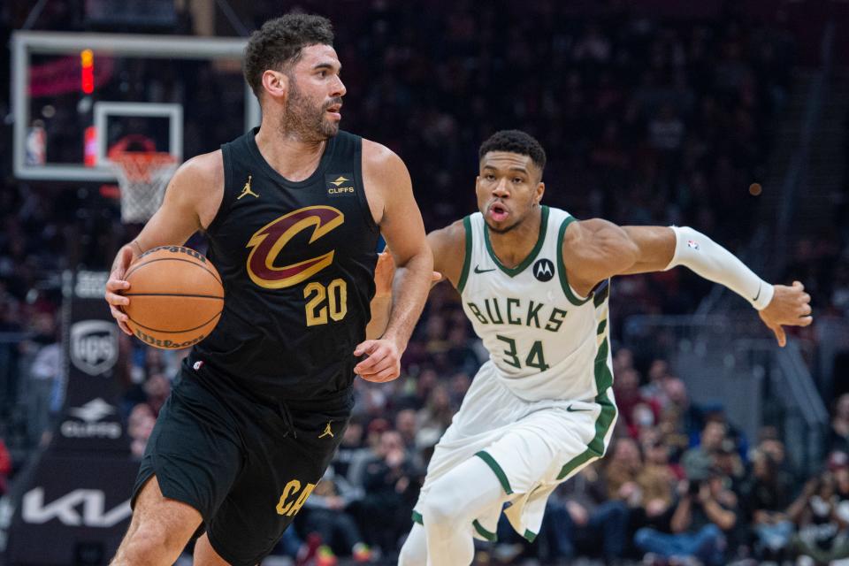 Cleveland Cavaliers' Georges Niang (20) drives past Milwaukee Bucks' Giannis Antetokounmpo (34) on Friday in Cleveland.