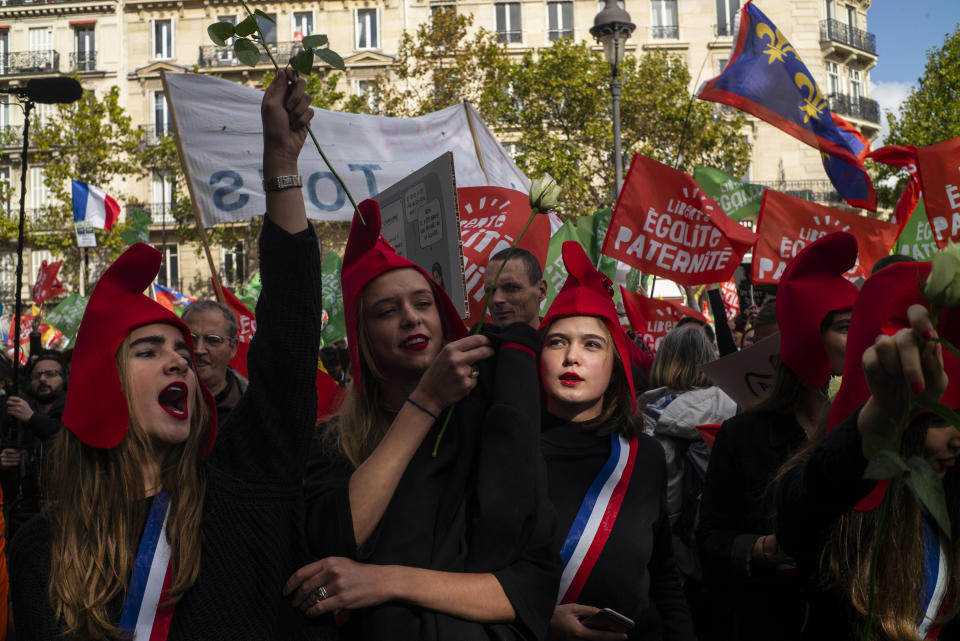 Conservative activists gather to protest in Paris, Sunday Oct. 6, 2019, against a French bill that would give lesbian couples and single women access to in vitro fertilization and related procedures. Traditional Catholic groups and far-right activists organized Sunday's protest, arguing that it deprives children of the right to a father. (AP Photo/Rafael Yaghobzadeh)