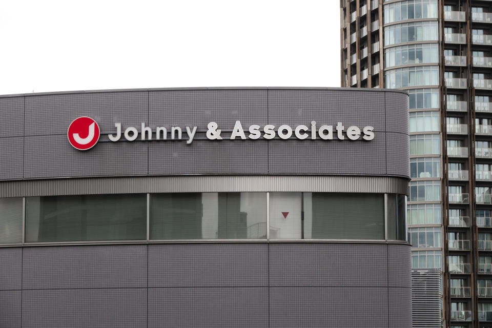 A sign hangs on the facade of the headquarters of Johnny & Associates talent agency founded by Johnny Kitagawa Wednesday, July 10, 2019, in Tokyo. Kitagawa, who produced famous boybands including Arashi and SMAP and was a kingpin of Japan’s entertainment industry for more than half a century, has died Tuesday from a subarachnoid hemorrhage at a Tokyo hospital. He was 87. (AP Photo/Jae C. Hong)