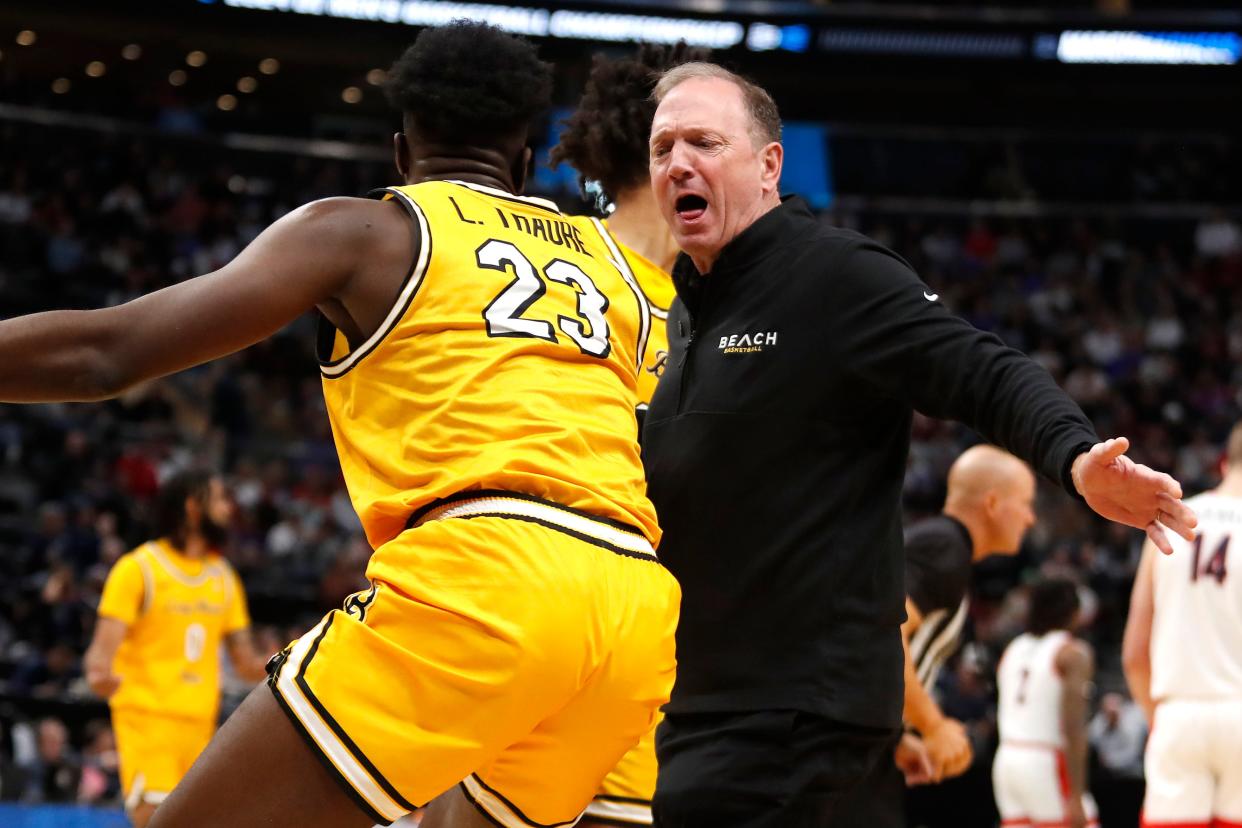 Long Beach State head coach Dan Monson helps Lassina Traore (23) to his feet in the first round of the NCAA Tournament against Arizona at Delta Center on March 21, 2024, in Salt Lake City, Utah.