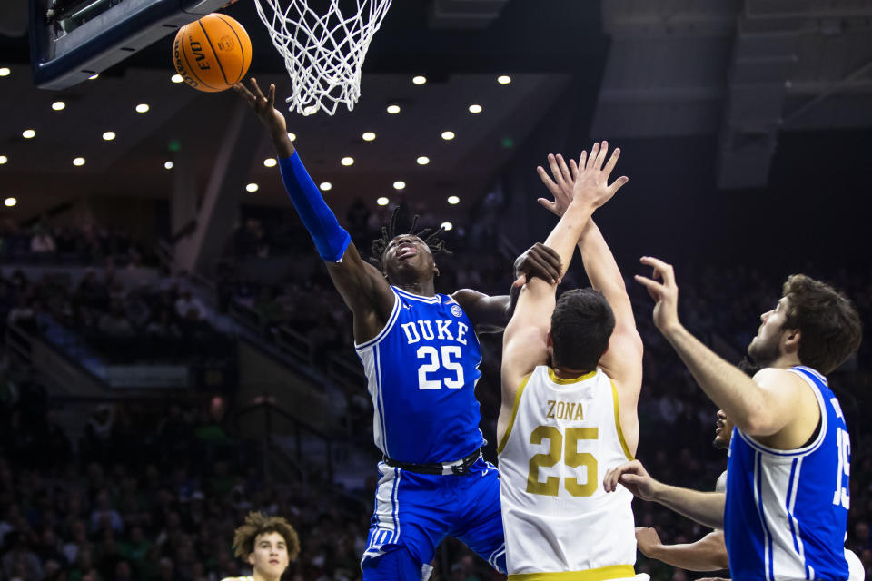 Duke's Mark Mitchell shoots next to Notre Dame's Matt Zona (25) as Duke's Ryan Young (15) watches during the first half of an NCAA college basketball game Saturday, Jan. 6, 2024, in South Bend, Ind. (AP Photo/Michael Caterina)