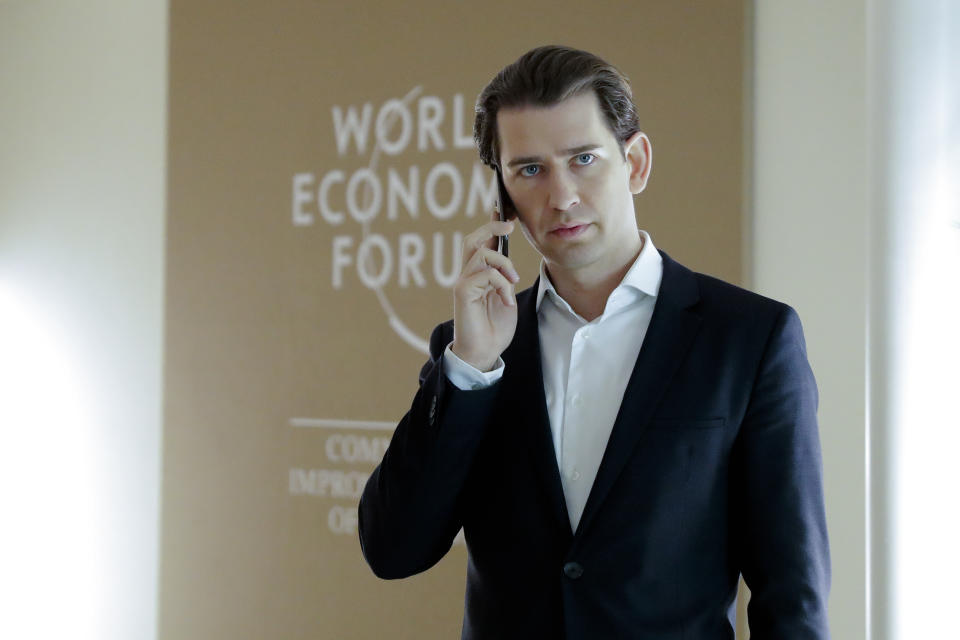 The Austrian Chancellor Sebastian Kurz, right, makes a phone call during the annual meeting of the World Economic Forum in Davos, Switzerland, Thursday, Jan. 24, 2019. (AP Photo/Markus Schreiber)