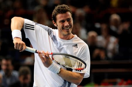 Marat Safin of Russia jokes during his match against Juan Martin Del Potro of Argentina in the Paris Masters Series tennis tournament November 11, 2009. REUTERS/Jacky Naegelen