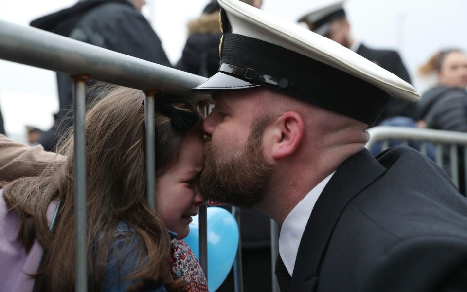 Petty Officer Adam Jeffrey (right) is greeted by his daughter Isabelle, 5 - Credit:  Andrew Matthews/PA