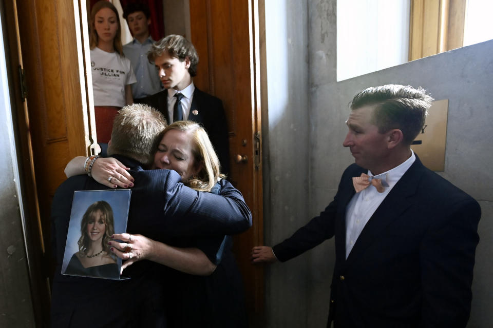 Jessica Ludwig holds a photo of her daughter, Jillian, as she hugs Rep. William Lamberth, R-Portland, after a bill passed in the House that would involuntarily commit certain criminal defendants for inpatient treatment and also temporarily remove their gun rights if they are ruled incompetent to stand trial due to intellectual disability or mental illness, Monday, April 15, 2024, in Nashville, Tenn. The bill is named for Jillian Ludwig, a Belmont University student killed last year by a stray bullet shot allegedly by a man the court had previously declared mentally incompetent. (AP Photo/Mark Zaleski)