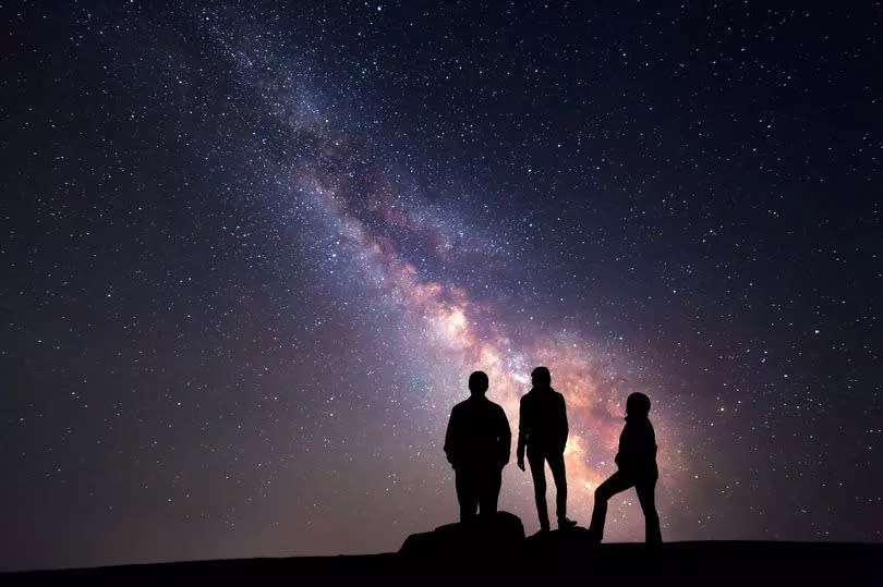 Stargazing family looking at the Milky Way -Credit:Getty