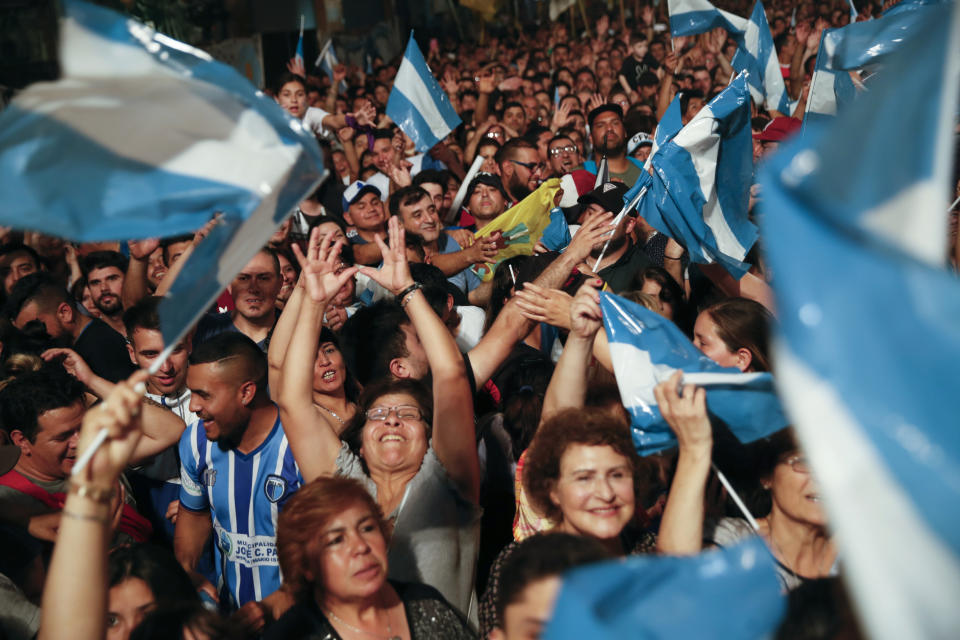 Supporters of Peronist presidential candidate Alberto Fernández and running mate, former President Cristina Fernández, celebrate after incumbent President Mauricio Macri conceded defeat at the end of election day in Buenos Aires, Argentina, Sunday, Oct. 27, 2019. (AP Photo/Natacha Pisarenko)