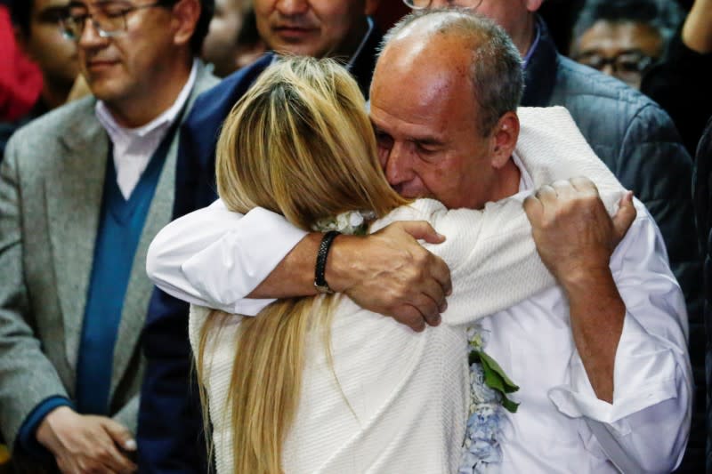 Bolivia’s interim President Jeanine Anez and Government Minister Arturo Murillo hug before a ceremony to announce her nomination as presidential candidate for the upcoming elections on May 3, in La Paz, Bolivia