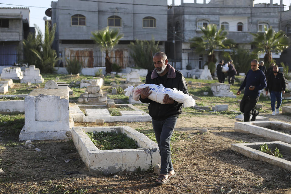 Palestinians carry the bodies of the Dhair family, killed in the Israeli bombardment of the Gaza Strip, during their funeral in Rafah on Friday, Dec. 22, 2023. (AP Photo/Hatem Ali)