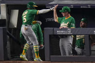 Oakland Athletics' Tony Kemp (5) is congratulated by manager Bob Melvin after hitting a three-run home run during the sixth inning of the team's baseball game against the New York Yankees on Friday, June 18, 2021, in New York. (AP Photo/Frank Franklin II)