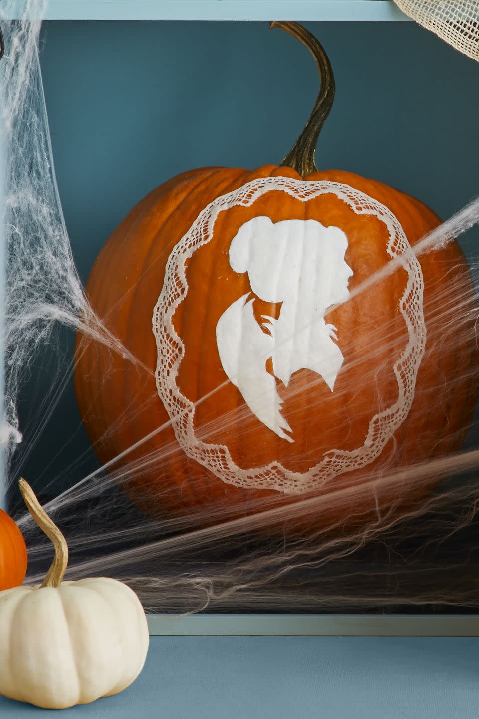 <p>Print out a silhouette on regular paper, cut it out, paint it whatever color you'd like, then attach it to the pumpkin with glue or double-sided tape. To add an extra touch, grab any lace you have laying around the house and use it as a frame around the silhouette cut-out<a href="https://hmg-prod.s3.amazonaws.com/files/pumpkin-cameo-f-1627665153.pdf?tag=syn-yahoo-20&ascsubtag=%5Bartid%7C10070.g.331%5Bsrc%7Cyahoo-us" rel="nofollow noopener" target="_blank" data-ylk="slk:;elm:context_link;itc:0;sec:content-canvas" class="link "><br></a></p><p>Get the <a href="https://hmg-prod.s3.amazonaws.com/files/pumpkin-cameo-f-1627665153.pdf?tag=syn-yahoo-20&ascsubtag=%5Bartid%7C10070.g.331%5Bsrc%7Cyahoo-us" rel="nofollow noopener" target="_blank" data-ylk="slk:Silhouette Pumpkin template;elm:context_link;itc:0;sec:content-canvas" class="link "><strong>Silhouette Pumpkin template</strong></a>.</p><p><a class="link " href="https://www.amazon.com/ilauke-Ribbon-Assorted-Pattern-Sewing/dp/B07TVNYD4G?tag=syn-yahoo-20&ascsubtag=%5Bartid%7C10070.g.331%5Bsrc%7Cyahoo-us" rel="nofollow noopener" target="_blank" data-ylk="slk:SHOP LACE RIBBON;elm:context_link;itc:0;sec:content-canvas">SHOP LACE RIBBON</a></p>