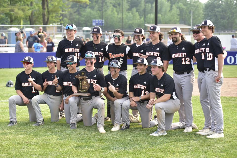 The Marine City baseball team poses for a photo after beating Macomb Lutheran North, 8-3, in a Division 2 district final at Richmond High School on Saturday.