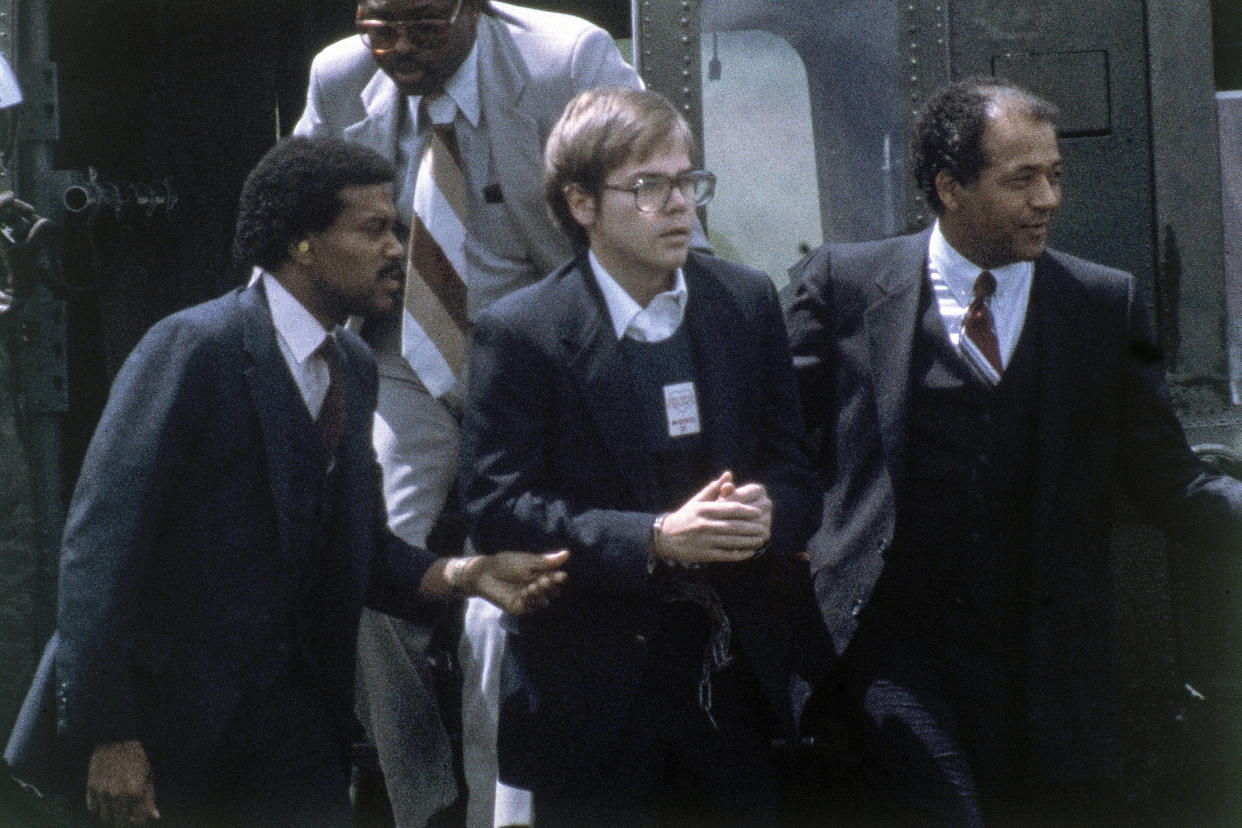 U.S. Marshalls escort John Hinckley Jr. as he returns to a marine base via helicopter in Quantico, Va., Aug. 8, 1981. (AP)