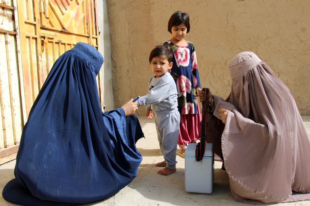 <span>Afghanistan and neighbouring Pakistan are the only countries where polio is still endemic and female health workers have been crucial to reaching children. ‘In those areas where we have female workers, we don’t have cases of polio,’ an official said of the ban.</span><span>Photograph: M Sadiq/EPA</span>